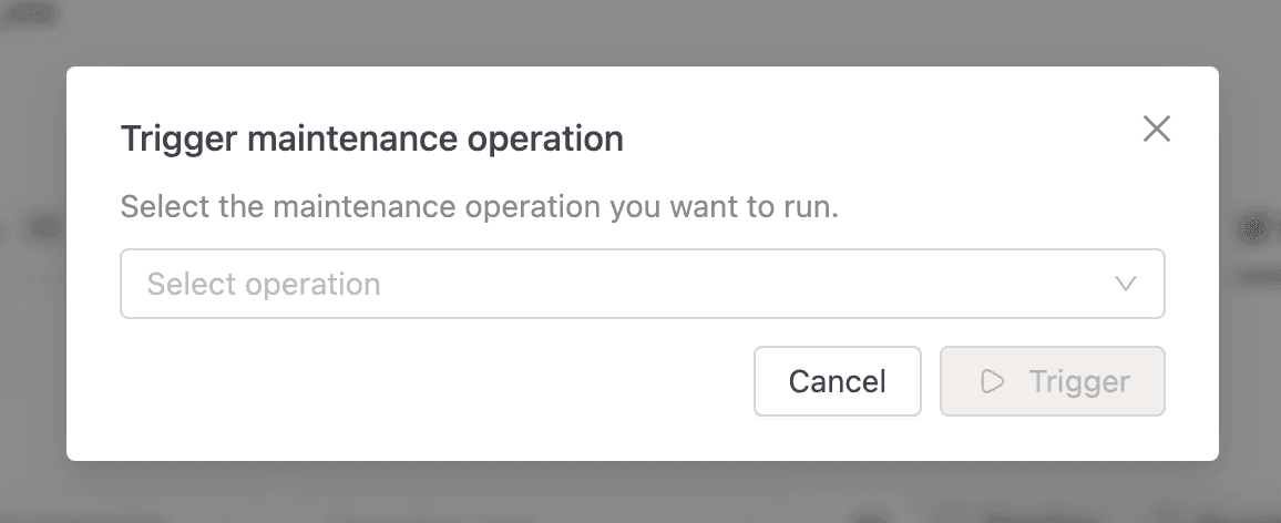Trigger maintenance operation dialog with a Select operation dropdown and Cancel and Trigger buttons | IOMETE