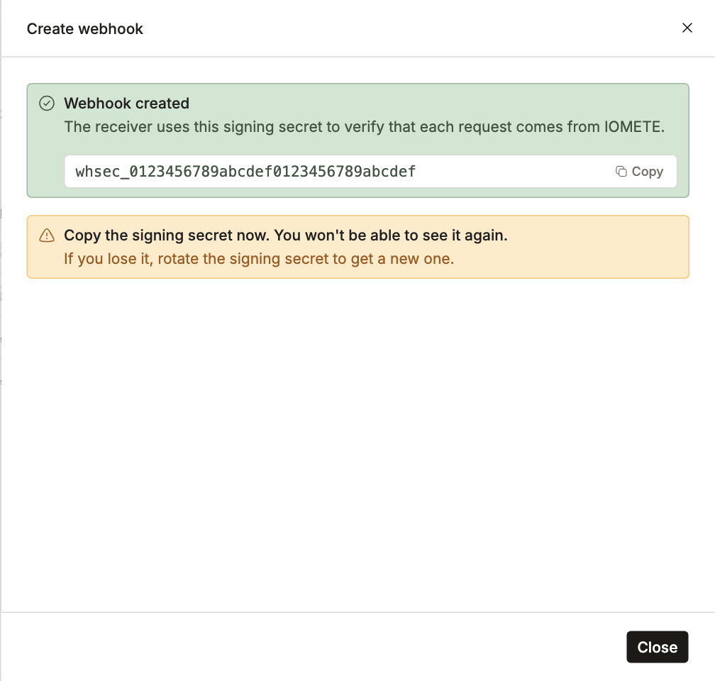 Webhook created panel showing the signing secret with a Copy button and a warning that it is shown only once | IOMETE